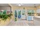 Well-lit kitchen with tile floors, white appliances, and garden views, with an adjacent door leading outside at 3614 Clearbrooke Way, Duluth, GA 30097