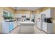 Traditional eat-in kitchen featuring tile floors, white cabinets and an island, providing ample counter space for meal preparation at 3614 Clearbrooke Way, Duluth, GA 30097