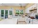 This kitchen offers white appliances and cabinets, a garden window, and a kitchen island, perfect for Gathering meals at 3614 Clearbrooke Way, Duluth, GA 30097
