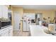An eat-in kitchen offers tile floors and white cabinets, providing plenty of storage and counter space for cooking at 3614 Clearbrooke Way, Duluth, GA 30097