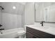 Modern bathroom with sleek finishes, featuring a soaking tub, a large mirror, and stylish fixtures at 202 Dawson Dr, Woodstock, GA 30188