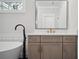 Modern bathroom with a vanity, black hardware, and a soaking tub at 202 Dawson Dr, Woodstock, GA 30188