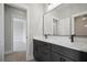 A luxurious bathroom showcasing a double sink vanity with black hardware and fixtures, plus a large mirror at 202 Dawson Dr, Woodstock, GA 30188