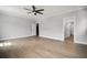 Spacious bedroom with modern design, featuring hardwood floors, bright windows and a ceiling fan at 202 Dawson Dr, Woodstock, GA 30188