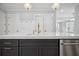Kitchen with dark lower cabinets, island sink, stainless steel dishwasher and open view at 202 Dawson Dr, Woodstock, GA 30188