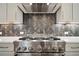 Close up of the stainless steel stove with herringbone backsplash at 202 Dawson Dr, Woodstock, GA 30188