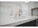 Kitchen with white cabinets, center sink, and stainless steel dishwasher at 202 Dawson Dr, Woodstock, GA 30188