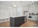 Stylish kitchen with a gray island, white cabinets, and stainless steel appliances at 202 Dawson Dr, Woodstock, GA 30188