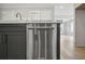 Kitchen with stainless steel dishwasher, dark cabinets, and marble countertops at 202 Dawson Dr, Woodstock, GA 30188