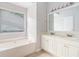 Bright bathroom featuring a soaking tub and double sink vanity at 2175 Golden Valley Dr, Lawrenceville, GA 30043