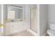 A bathroom vanity with double sinks and a glass door shower, all illuminated by overhead lighting at 2175 Golden Valley Dr, Lawrenceville, GA 30043