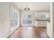 Dining room with hardwood floors, neutral walls, and bright windows providing ample natural light with chandelier at 2175 Golden Valley Dr, Lawrenceville, GA 30043