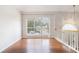 Entryway with a transom window above a white door, hardwood floors, and lots of natural light streaming through windows at 2175 Golden Valley Dr, Lawrenceville, GA 30043
