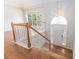 Inviting foyer with wood floors, staircase and arched entryway with a transom window and stylish pendant lighting at 2175 Golden Valley Dr, Lawrenceville, GA 30043