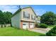 Home exterior highlighting the two-car garage, beautiful lawn, and driveway at 2175 Golden Valley Dr, Lawrenceville, GA 30043