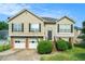 Charming two-story home with a two-car garage and well-manicured lawn at 2175 Golden Valley Dr, Lawrenceville, GA 30043