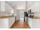 Spacious kitchen with white cabinets, stainless steel appliances, granite counters and hardwood floors at 2175 Golden Valley Dr, Lawrenceville, GA 30043
