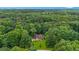 Expansive aerial shot showcasing the home nestled within a lush green forest, offering serene privacy at 3488 Pebble Brook Ln, Stockbridge, GA 30281