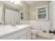 Bathroom with a white single vanity, a toilet, a window and shower with curtain at 3488 Pebble Brook Ln, Stockbridge, GA 30281
