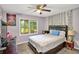 Bedroom featuring a queen size bed, desk, window, and ceiling fan at 3488 Pebble Brook Ln, Stockbridge, GA 30281