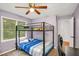 Bedroom with bunkbeds, desk, carpet, ceiling fan, and a light purple color scheme at 3488 Pebble Brook Ln, Stockbridge, GA 30281