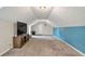 Spacious bonus room features plush carpeting and a large television set for entertainment at 3488 Pebble Brook Ln, Stockbridge, GA 30281