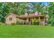 Attractive home showcasing stone facade, dormer windows, and vibrant front yard landscaping at 3488 Pebble Brook Ln, Stockbridge, GA 30281