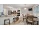 Open concept kitchen with granite countertops, stainless steel appliances, island seating, and tile flooring at 3488 Pebble Brook Ln, Stockbridge, GA 30281