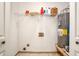 Functional laundry room with tile flooring, a water heater, and wire storage shelves at 3488 Pebble Brook Ln, Stockbridge, GA 30281