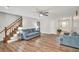 Spacious living room with hardwood floors, staircase, comfortable seating, and a bright, airy atmosphere at 3488 Pebble Brook Ln, Stockbridge, GA 30281