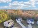 A tranquil aerial view showcasing the neighborhood with homes surrounded by a vibrant display of autumnal colors at 382 Daffodil Dr, Temple, GA 30179