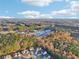 Aerial view showcases the home's location amidst a wooded area and proximity to nearby amenities at 382 Daffodil Dr, Temple, GA 30179