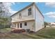 Back of house with a small patio area, HVAC unit, and a view of trees at 382 Daffodil Dr, Temple, GA 30179