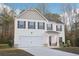 Classic two-story home features white siding, dark shutters, covered entry, and a manicured front lawn at 382 Daffodil Dr, Temple, GA 30179