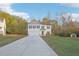 A two-story home with white siding, dark shutters, and a two-car garage on a large grassy lawn at 382 Daffodil Dr, Temple, GA 30179