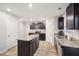Bright kitchen features granite countertops, stainless steel microwave, and central island with wood floors at 382 Daffodil Dr, Temple, GA 30179