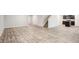 Expansive living area features wood-look floors, a staircase, and a modern kitchen with dark cabinetry at 382 Daffodil Dr, Temple, GA 30179