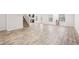 A spacious living space with a staircase, bar, door to the outside, and several windows at 382 Daffodil Dr, Temple, GA 30179