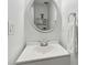 Elegant powder room with modern fixtures, a round mirror and a clean, white vanity at 570 White Stag Ct, Suwanee, GA 30024