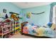 Brightly decorated bedroom with large windows, playful decor, and comfortable twin bed at 570 White Stag Ct, Suwanee, GA 30024