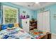 Brightly decorated bedroom with large windows, playful decor, and comfortable twin bed at 570 White Stag Ct, Suwanee, GA 30024