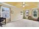 Bright bedroom with neutral walls, tray ceiling, dual windows and space for a home office at 570 White Stag Ct, Suwanee, GA 30024