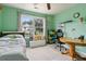 Comfortable bedroom featuring green walls, a comfortable bed, and a spacious desk area at 570 White Stag Ct, Suwanee, GA 30024