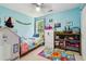 Charming bedroom with bright blue walls, playful decor, and plenty of natural light at 570 White Stag Ct, Suwanee, GA 30024