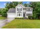 Charming two-story home with stone accents, well-manicured lawn, and a two-car garage at 570 White Stag Ct, Suwanee, GA 30024