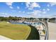 Modern exterior view overlooking a large park with pedestrian bridge and water feature; many buildings in the background at 570 White Stag Ct, Suwanee, GA 30024