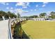 Elevated view over a large park with pedestrian bridge and waterfall feature; meticulously maintained green lawn at 570 White Stag Ct, Suwanee, GA 30024