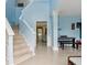Bright, airy foyer with staircase and porcelain tile flooring at 570 White Stag Ct, Suwanee, GA 30024