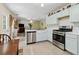 Open kitchen concept showcasing stainless steel appliances and seamless flow into the living area at 570 White Stag Ct, Suwanee, GA 30024