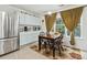 Bright eat-in kitchen featuring stainless steel appliances and large windows with backyard views at 570 White Stag Ct, Suwanee, GA 30024